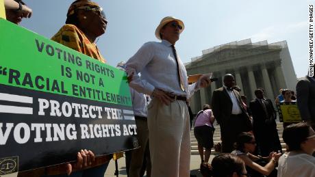 Supporters of the Voting Rights Act listen to speakers discussing rulings outside the US Supreme Court building on June 25, 2013 in Washington.