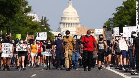 Demonstrators march down Pennsylvania Avenue  during a protest against police brutality and the death of George Floyd on June 3, 2020, in Washington.