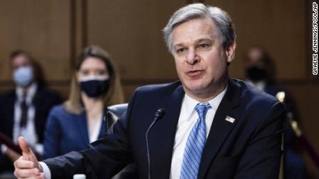 FBI director says bureau is not investigating QAnon conspiracy 'in its own right' 