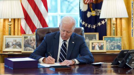 Biden signs the American Rescue Plan on March 11, 2021.