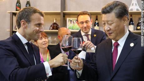 Chinese President Xi Jinping and French Emmanuel Macron (taste wine as they visit France's pavilion during the China International Import Expo in Shanghai on November 5, 2019.