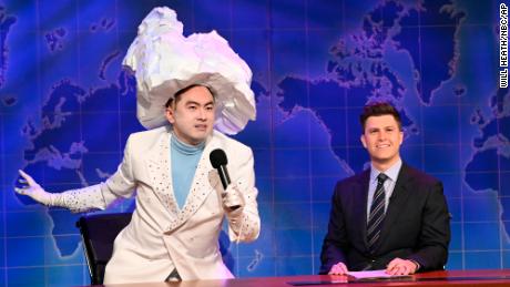 Bowen Yang as the Iceberg that sank the Titanic, left, and anchor Colin Jost during Weekend Update on &quot;Saturday Night Live&quot; in New York on April 10, 2021. 