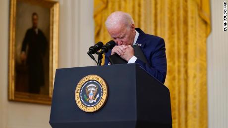 President Joe Biden pauses as he listens to a question about the bombings at the Kabul airport that killed at least 12 U.S. service members, from the East Room of the White House in August 2021.