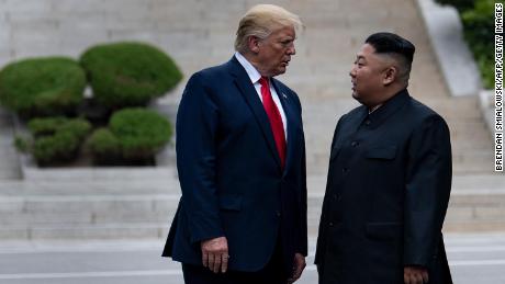 Then-President Donald Trump and North Korea's leader Kim Jong-un stand on North Korean soil while walking to South Korea in the Demilitarized Zone in June 2019. Some records involving correspondence with Kim were among those sought by the Archives.